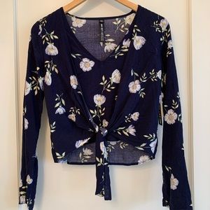 Never worn with tags. Floral long sleeved blouse.